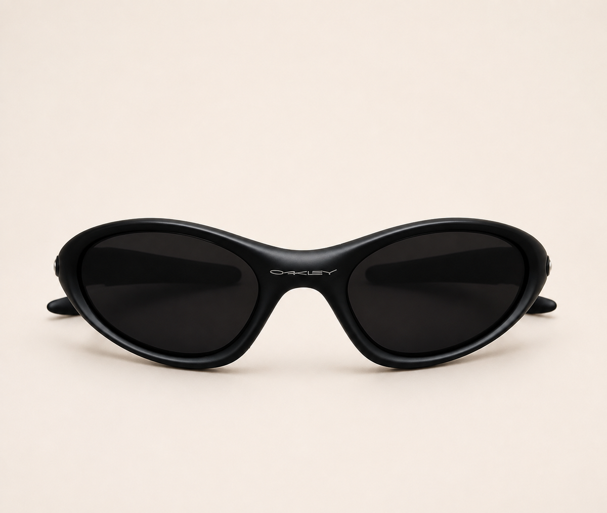 Front view of black Oakley Minute sunglasses with dark lenses and a curved wraparound frame.