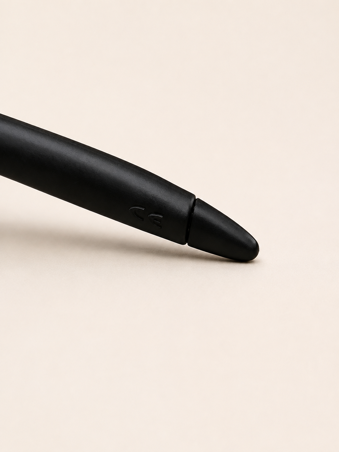 Close-up of the black Oakley Minute temple arm and earpiece, showing the embossed CE marking.