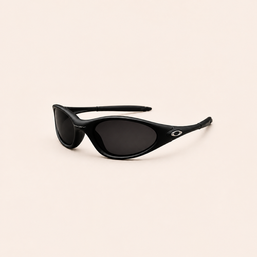 Oakley Minute black sunglasses with dark lenses and silver oval temple details, three-quarter view on a cream background.