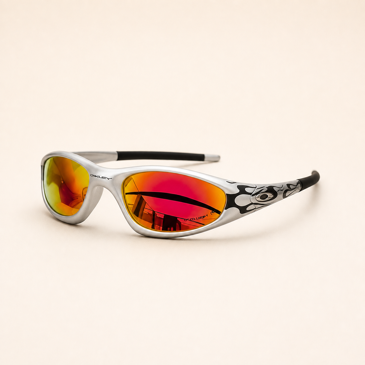 Opposite three-quarter view of Oakley Minute Silver / Black Flames sunglasses, showing black temple graphics and mirrored red-orange lenses.