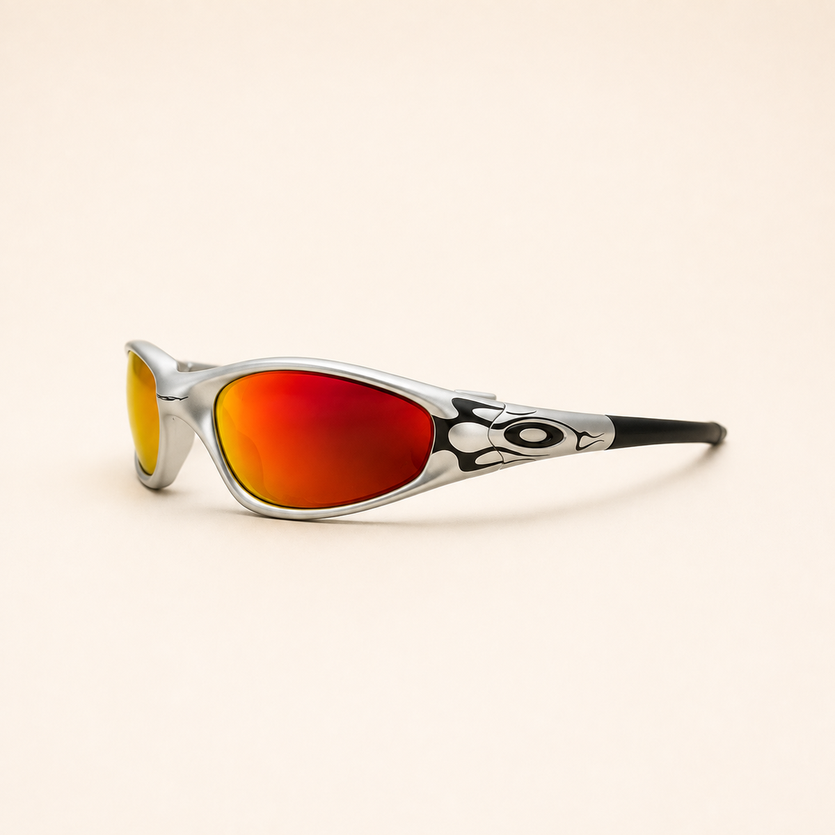 Angled side view of Oakley Minute Silver / Black Flames sunglasses, showing the black flame pattern and red-orange mirrored lens.